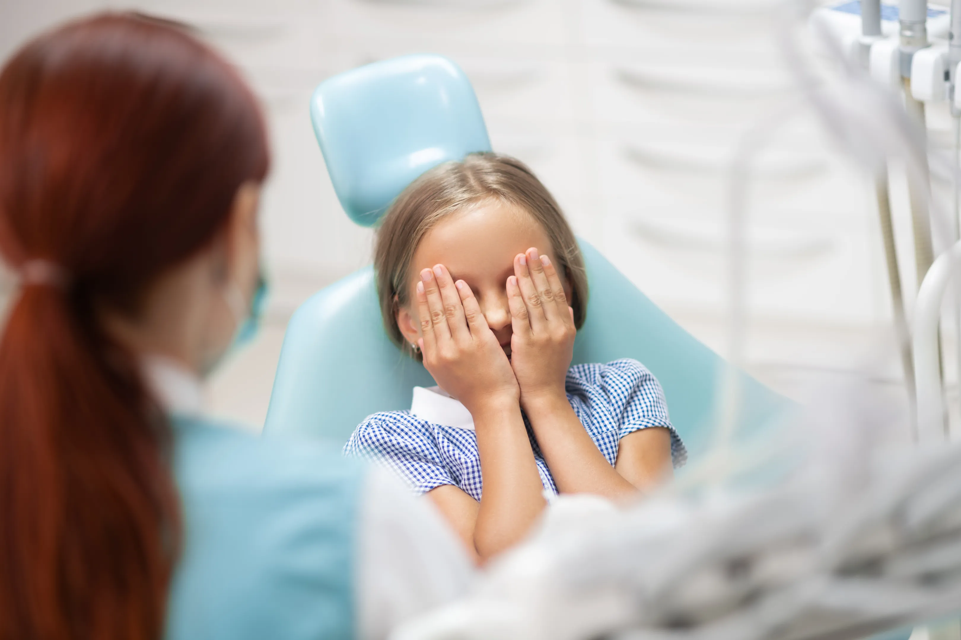 Therapy dog helping nervous young patient at dentist